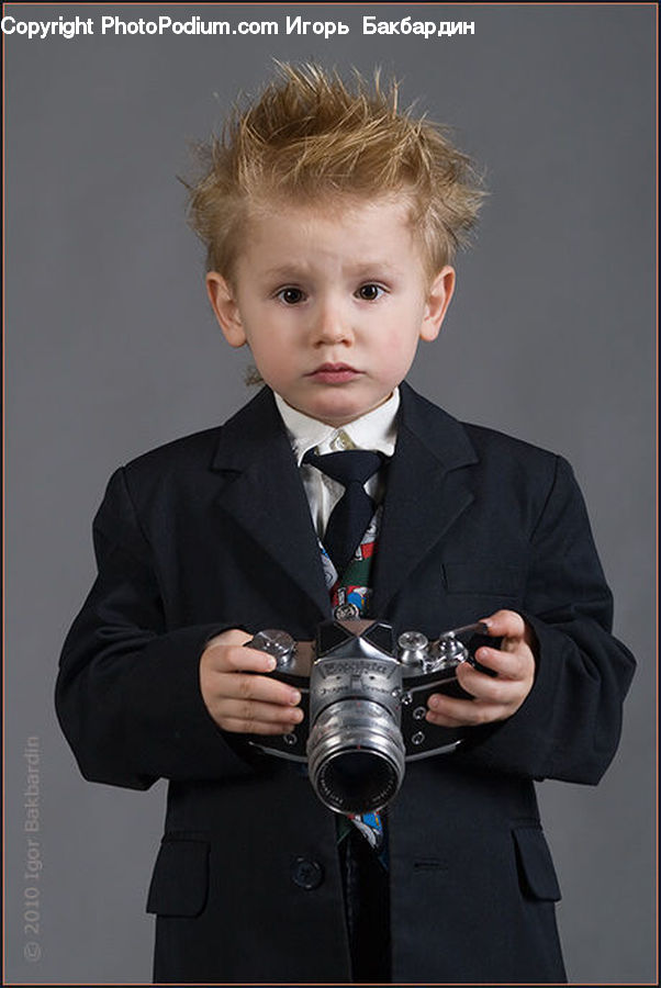 People, Person, Human, Clothing, Overcoat, Suit, Camera