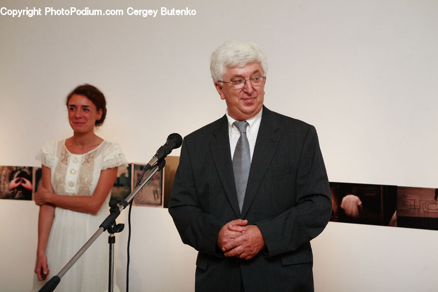 People, Person, Human, Clothing, Overcoat, Suit, Sitting