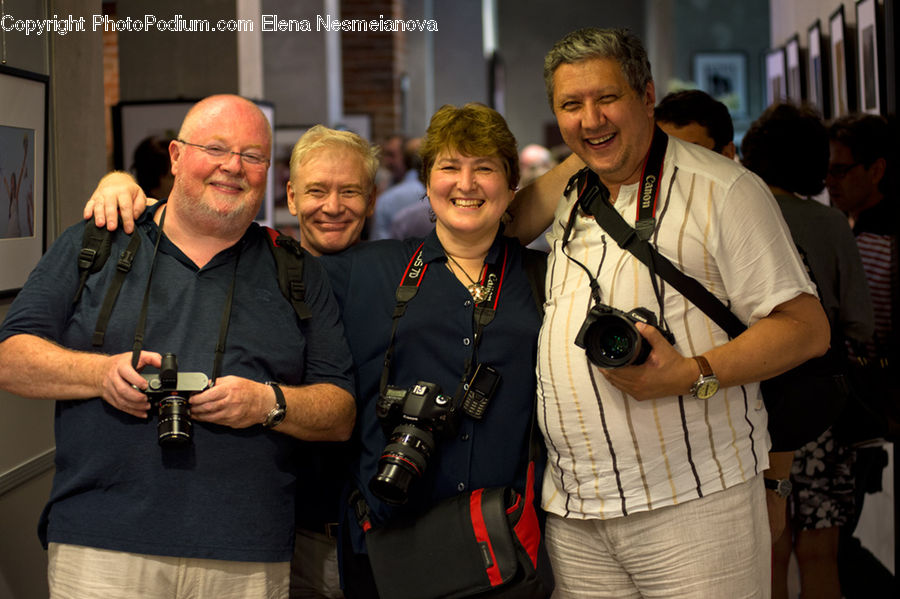 People, Person, Human, Camera, Electronics, Sitting, Apparel
