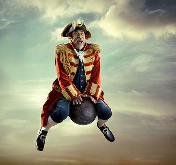 Baron von Munchausen flying on cannon balls